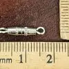 Small silver magnetic clasp with single loop end shown next to ruler for size scale