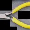Photo of a pair of yellow pliers laying on a table